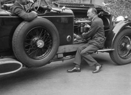 Geoffrey Baker inspecting the engine of a Minerva car. Artist: Bill Brunell.