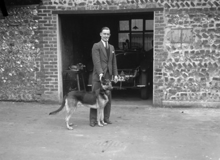 Geoffrey Baker and his alsatian. Artist: Bill Brunell.
