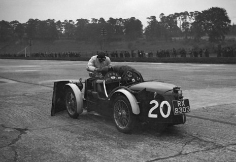 Mechanic making adjustments to a MG C type, Brooklands. Artist: Bill Brunell.