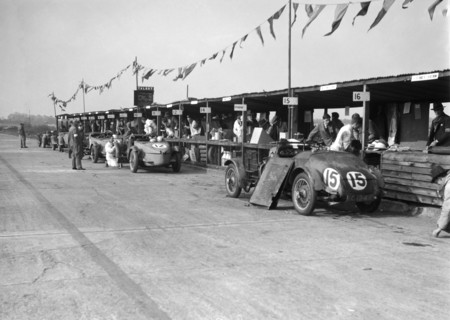Talbot 105 and Lea-Francis cars in the pits at the JCC Double Twelve race, Brooklands, 8/9 May 1931. Artist: Bill Brunell.