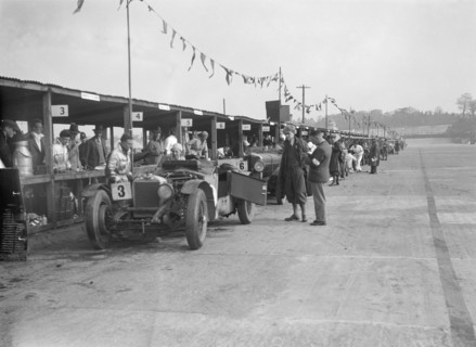 Invicta of FH Cairnes and George Field in the pits at the JCC Double Twelve race, Brooklands, 1931. Artist: Bill Brunell.