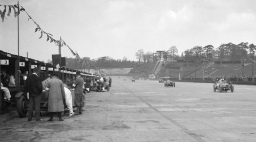 Invicta leading a Riley 9 Brooklands in the JCC Double Twelve race, Brooklands, 8/9 May 1931. Artist: Bill Brunell.
