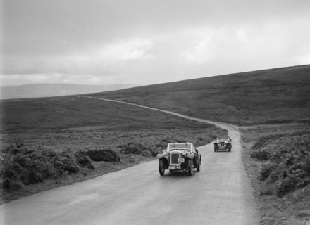 Austin 7 AEW of AL Chard ahead of FG Cornish's MG TA at the MCC Torquay Rally, July 1937. Artist: Bill Brunell.