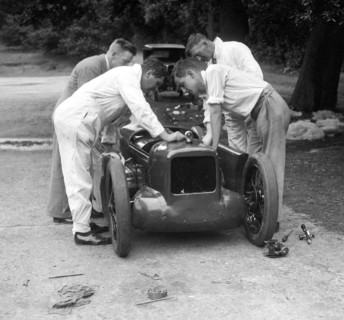 Mechanics working on Leon Cushman's Austin 7 racer for a speed record attempt, Brooklands, 1931. Artist: Bill Brunell.