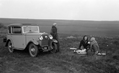 Three women having a picnic during a road test of a Triumph Scorpion, 1931. Artist: Bill Brunell.
