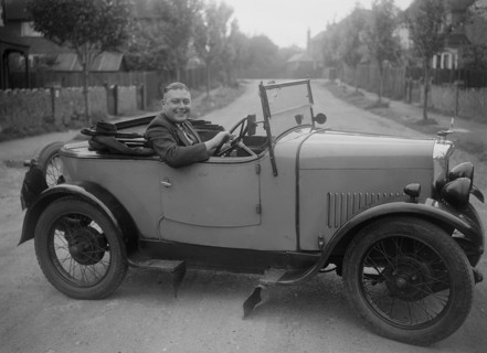 FA Thatcher behind the wheel of a 1929 Triumph Super Seven open four-seater. Artist: Bill Brunell.