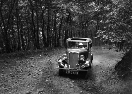 Singer Nine saloon competing in the B&HMC Brighton-Beer Trial, Fingle Bridge Hill, Devon, 1934. Artist: Bill Brunell.