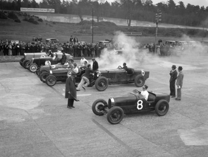 Cars on the start line at a BARC meeting, Brooklands, 1930. Artist: Bill Brunell.