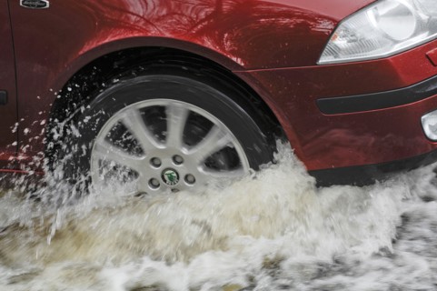 Car driving through flood. Artist: Unknown.