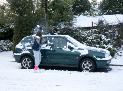 Girls palying with snowballs by VW Golf 2009 Artist: Unknown.