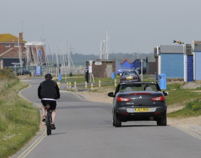 Mitsubishi Colt CZC cabriolet overtaking cyclist