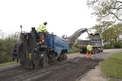 Road resurfacing work repairing potholes Artist: Unknown.