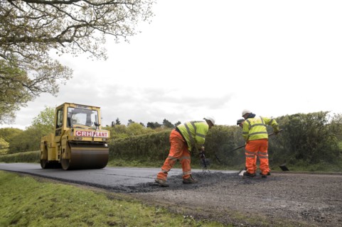 Road resurfacing work repairing potholes Artist: Unknown.