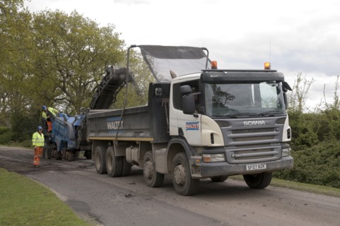 Road resurfacing work repairing potholes Artist: Unknown.