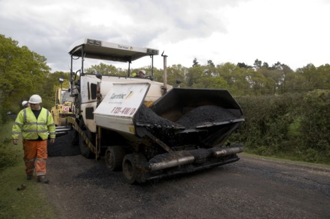Road resurfacing work repairing potholes Artist: Unknown.