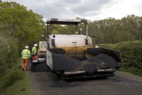 Road resurfacing work repairing potholes Artist: Unknown.