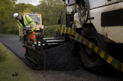 Road resurfacing work repairing potholes Artist: Unknown.