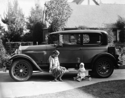 Stan Laurel at the wheel of 1927 Hupmobile with his wife Lois and daughter Lois  Artist: Unknown.
