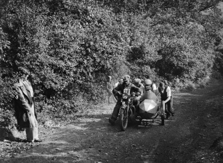 Motorcycle and sidecar competing in the Brighton and Hove Motor Club Brighton-Beer Trial, 1930. Artist: Bill Brunell.