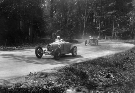 TP Cholmondeley-Tapper's Bugatti Type 37A leading a Frazer-Nash TT replica at Donington Park, 1930s. Artist: Bill Brunell.
