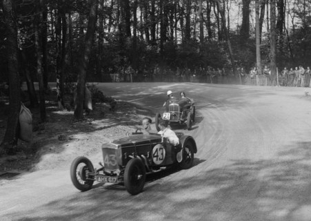 Frazer-Nash TT replica leading a Wolseley Hornet at Donington Park, Leicestershire, 1930s. Artist: Bill Brunell.