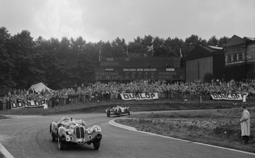 Alfa Romeo of Hugh Hunter leading a Riley at Crystal Palace, London, 1939. Artist: Bill Brunell.