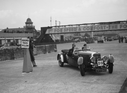 Aston Martin 4-seat open tourer competing in the JCC Rally, Brooklands, Surrey, 1939. Artist: Bill Brunell.