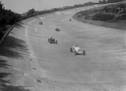 Bugatti T37s of Eileen Ellison and S Smith on Byfleet Banking, BARC meeting, Brooklands, 1933. Artist: Bill Brunell.