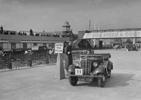 Morris 8 tourer competing in the JCC Rally, Brooklands, Surrey, 1939. Artist: Bill Brunell.