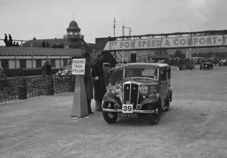 Standard Nine saloon competing in the JCC Rally, Brooklands, Surrey, 1939. Artist: Bill Brunell.
