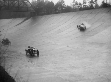 Austin 7 and the spinning Riley of HL Roberts, BARC Mountain Race, Brooklands, Surrey, 1931 Artist: Bill Brunell.