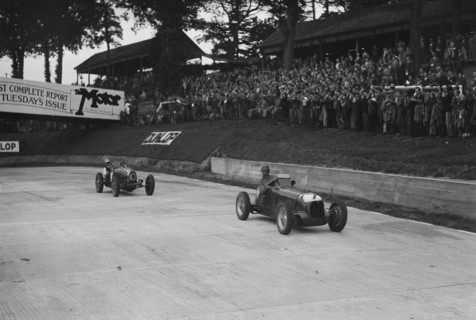 Maserati leading Charles Mortimer's Bugatti Type 35B at Brooklands, Surrey, 1939. Artist: Bill Brunell.