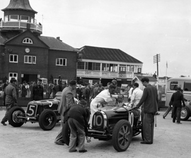 ERA and Charles Mortimer's Bugatti Type 35B at Brooklands, Surrey, 1939. Artist: Bill Brunell.