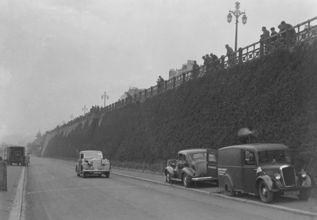 Daimler of CM Simpson and a Morris loudspeaker van on Madeira Drive, Brighton, RAC Rally, 1939. Artist: Bill Brunell.