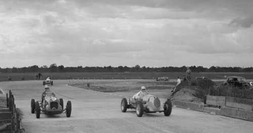 Two MGs racing at Brooklands, Surrey, c1930s. Artist: Bill Brunell.