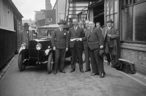 Group of men with a Triumph Super Seven, c1930(?). Artist: Bill Brunell.