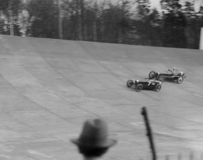 Bugatti Type 35 of EM Thomas and Ballot of Jack Dunfee racing at a BARC meeting, Brooklands, 1930. Artist: Bill Brunell.