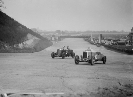 Bentley of Major H Butler and Lea-Francis Hyper racing at a BARC meeting, Brooklands, 1930. Artist: Bill Brunell.