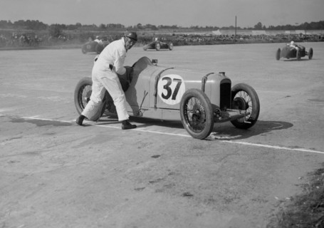 Charles Martin restarting his Amilcar after skidding, JCC 200 Mile Race, Brooklands, 1926. Artist: Bill Brunell.