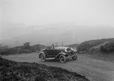 Kitty Brunell driving a 1930 2-seater Ford Model A, 1931.   Artist: Bill Brunell.