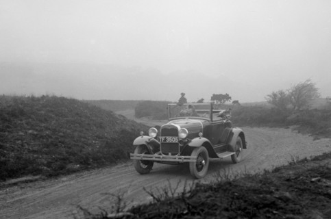 Kitty Brunell driving a 1930 2-seater Ford Model A, 1931.   Artist: Bill Brunell.