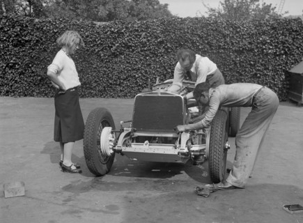 Working on the engine of Raymond Mays' Vauxhall-Villiers, c1930s. Artist: Bill Brunell.
