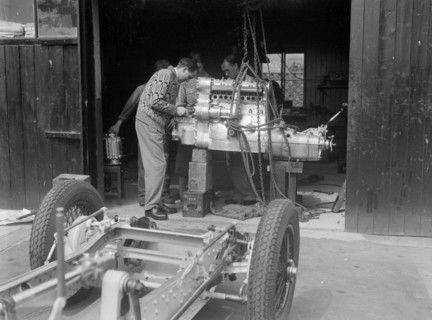 Working on the engine of Raymond Mays' Vauxhall-Villiers, c1930s. Artist: Bill Brunell.