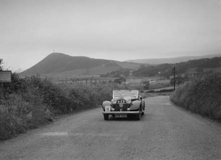 Jensen open 4-seater of Ken Crawford competing in the South Wales Auto Club Welsh Rally, 1937 Artist: Bill Brunell.