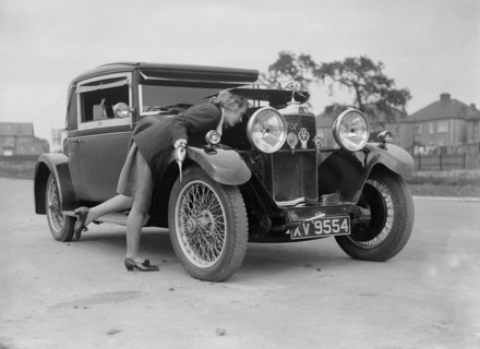 Kitty Brunell looking under the bonnet of a Talbot 14/45 sportsman's coupe, c1928. Artist: Bill Brunell.
