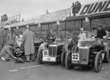 Three MG C type Midgets in the pits at the RAC TT Race, Ards Circuit, Belfast, 1932. Artist: Bill Brunell.