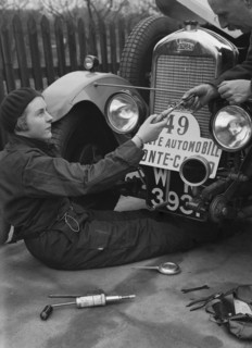 Kitty Brunell working on her Singer Junior, Monte Carlo Rally, 1928. Artist: Bill Brunell.