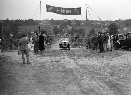 Austin Swallow of Mrs A Stanley at the finish of the Middlesex County AC Hill Climb, c1930. Artist: Bill Brunell.