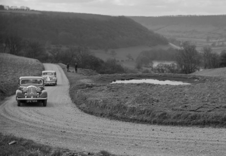 Rover of BN Wilmott and Jaguar SS of Dr AR Gray competing in the RAC Rally, 1939. Artist: Bill Brunell.
