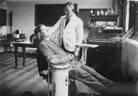 Dentist examines a male patient, Rowntree Factory, York, Yorkshire, 1920. Artist: Unknown